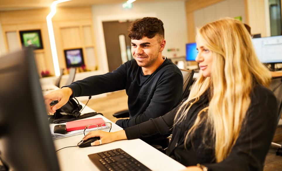 Employees interacting at desks