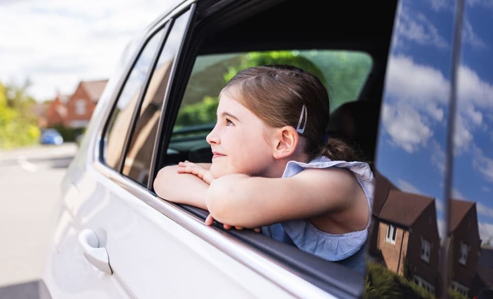 child looking out the car window